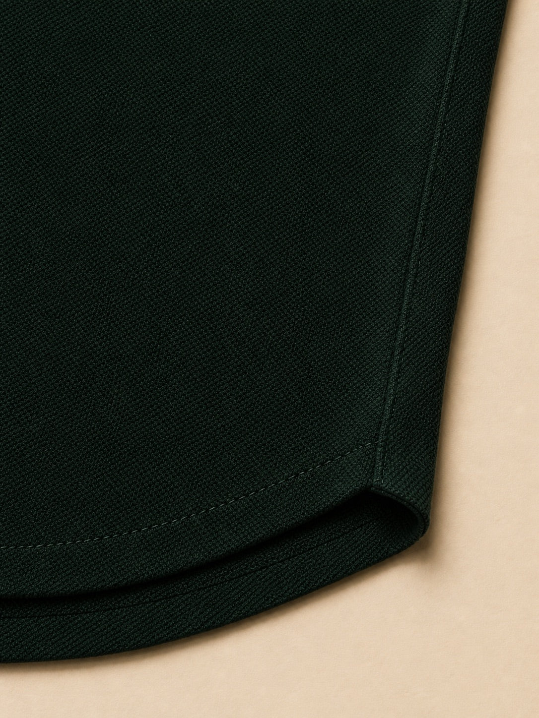 Close-up of the Aarsag long-sleeve polo fabric texture and hem